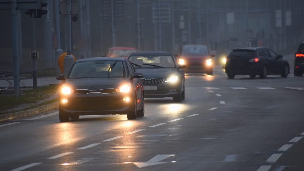 cars driving with headlights on